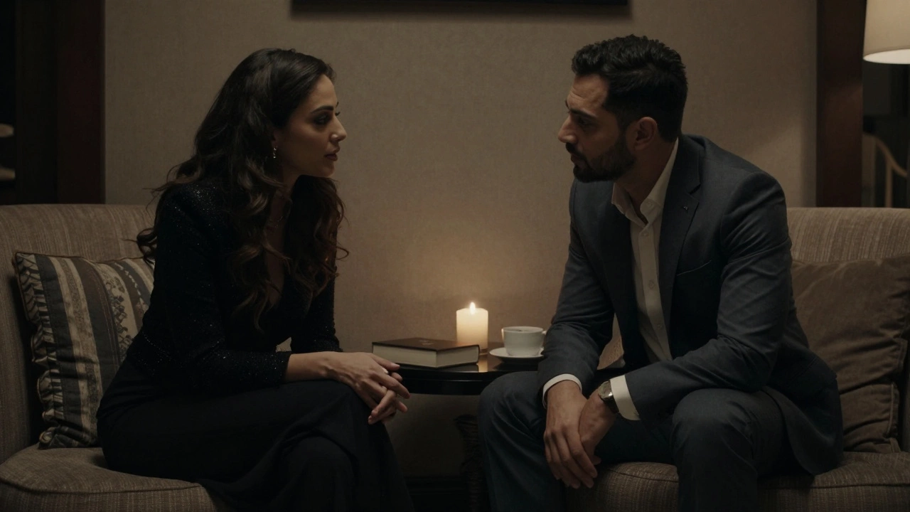 Two people share a quiet, intimate conversation in a dimly lit hotel lounge, no devices in sight.